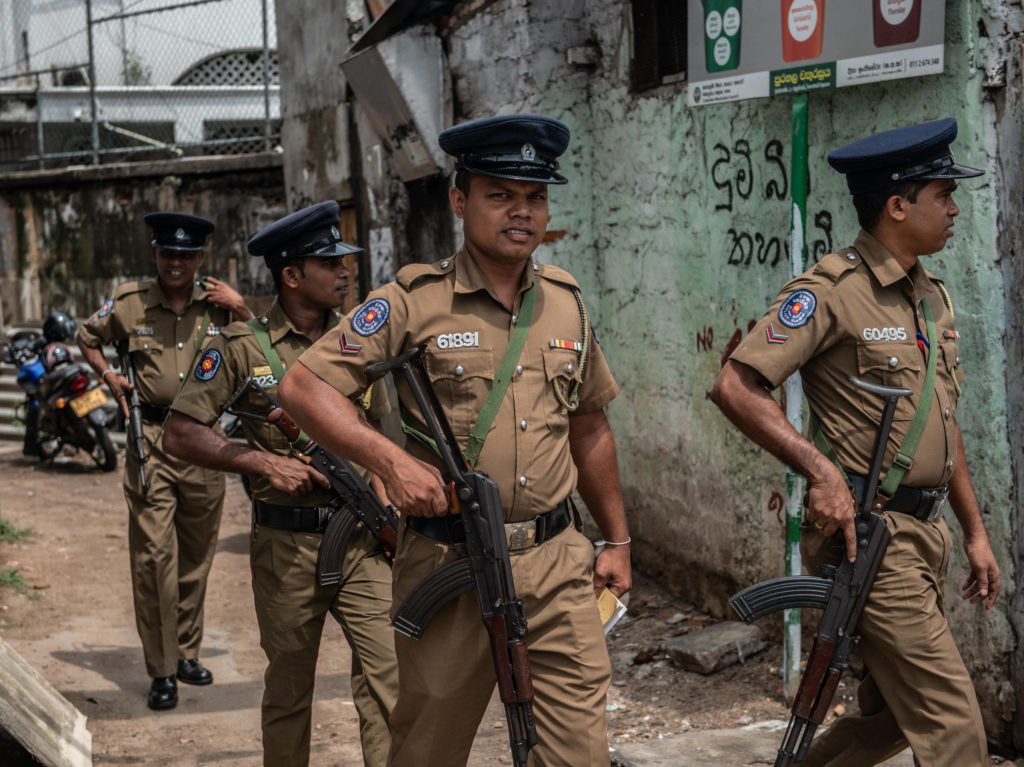 Police officers patrol the area around Dawatagaha mosque ahead of prayers on Friday in Colombo, Sri Lank