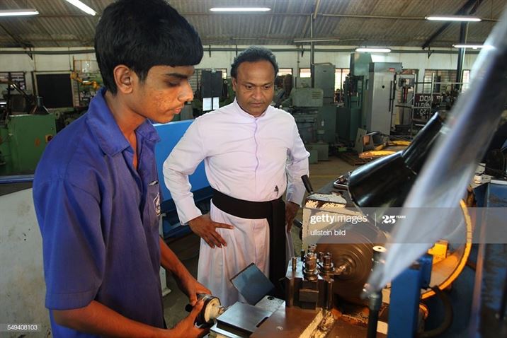 (GERMANY OUT) LKA, Sri Lanka, Negombo: Father Shiran, leader of the Don Bosco technical center and a trainee working on a maschine (Photo by Markus Matzel/ullstein bild via Getty Images)